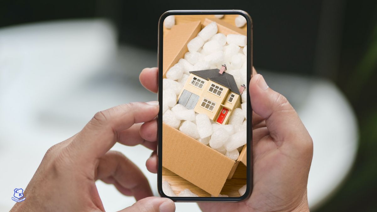 Hand holding phone taking photograph of moving box contents - Casey's Removals
