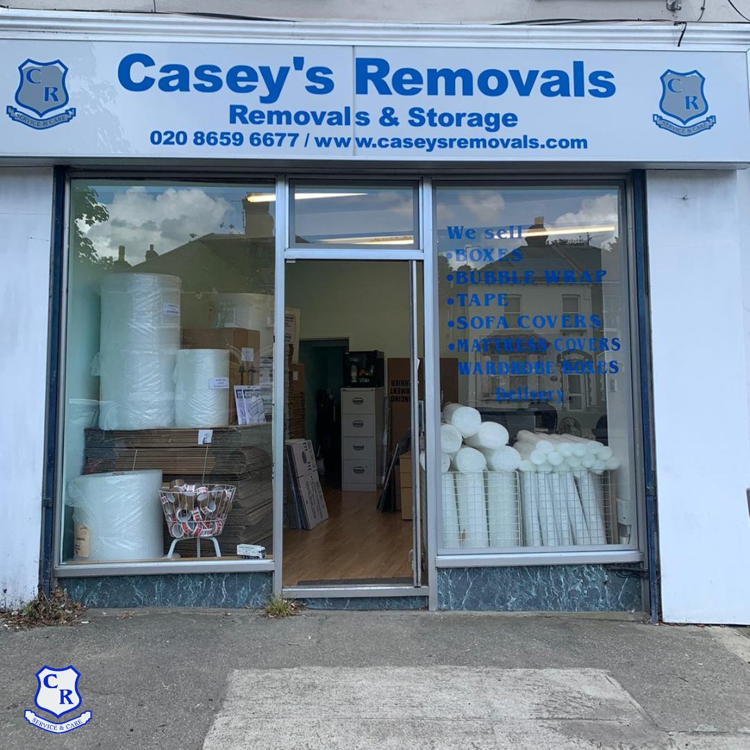 Exterior of Casey's Removals shop with bubble wrap and boxes in window